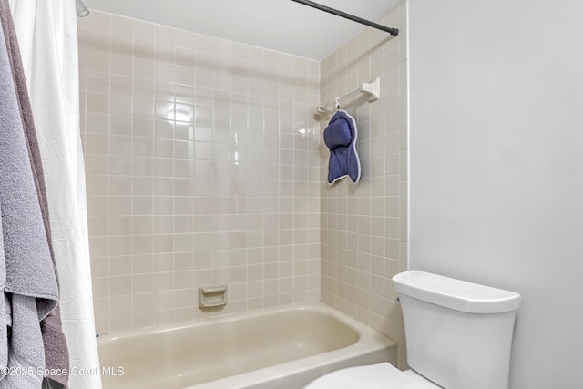 bathroom with shower / bath combo and toilet