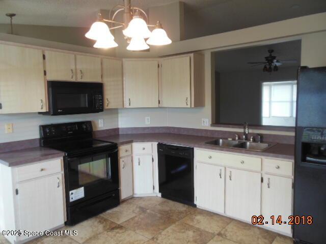 kitchen with hanging light fixtures, sink, ceiling fan with notable chandelier, and black appliances