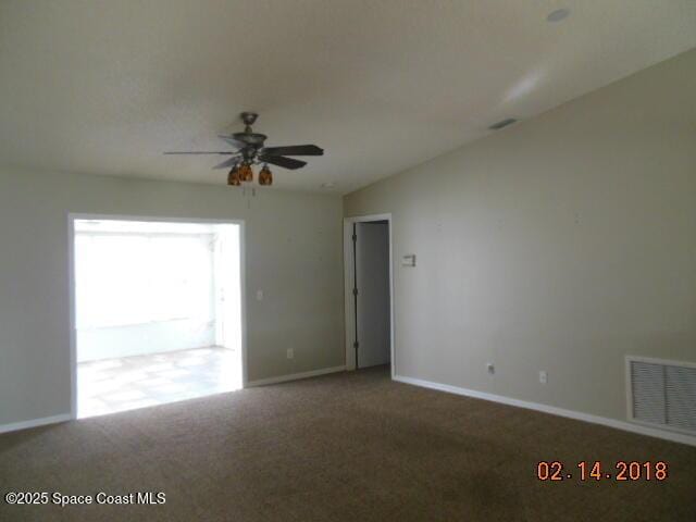 unfurnished room featuring carpet floors, ceiling fan, and vaulted ceiling