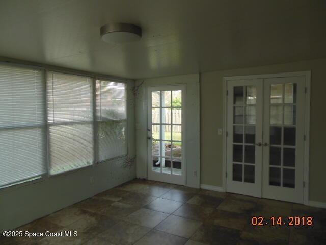 unfurnished sunroom featuring french doors