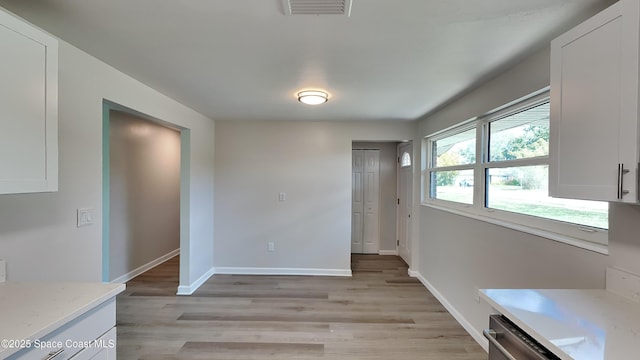 unfurnished dining area featuring light hardwood / wood-style flooring