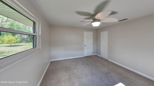 unfurnished room with light carpet and ceiling fan