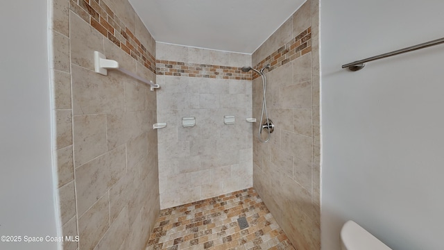 bathroom with tiled shower