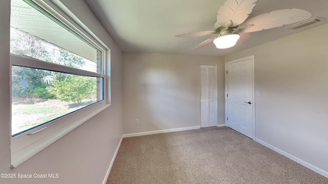 carpeted empty room with ceiling fan