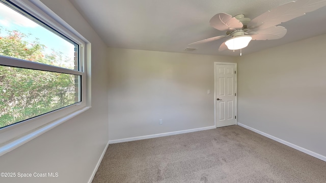 carpeted empty room featuring ceiling fan