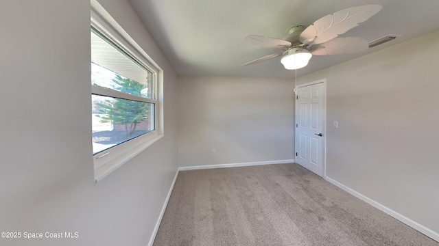 unfurnished room featuring light carpet and ceiling fan