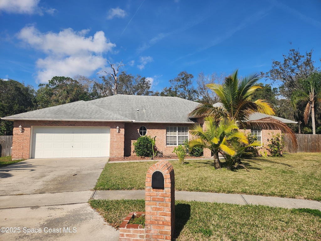 single story home featuring a garage and a front yard