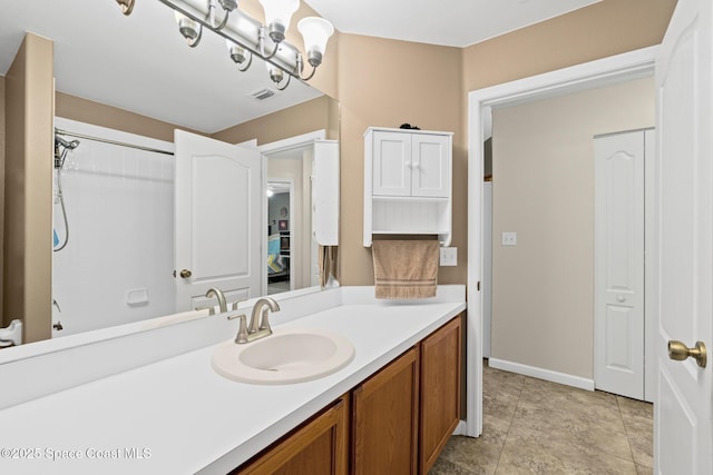 bathroom featuring visible vents, vanity, and baseboards