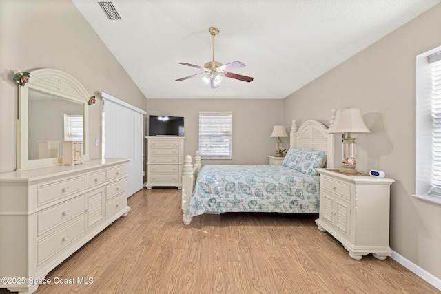 bedroom with vaulted ceiling, baseboards, visible vents, and light wood finished floors