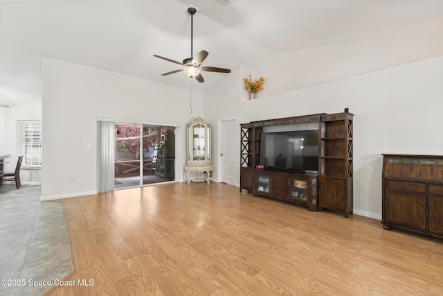 unfurnished living room featuring high vaulted ceiling, baseboards, light wood-style floors, and a ceiling fan