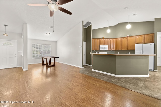 kitchen featuring white appliances, a ceiling fan, hanging light fixtures, light wood-style floors, and brown cabinets