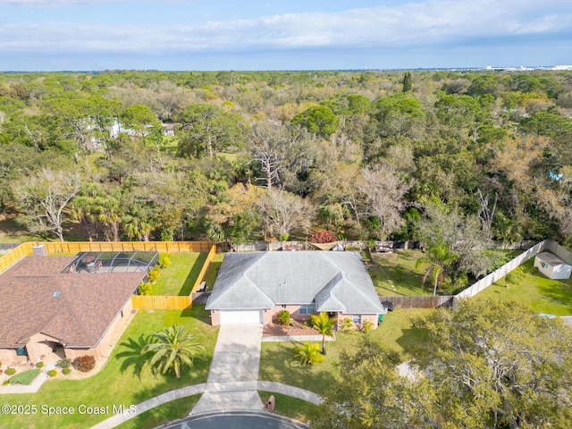 birds eye view of property featuring a view of trees