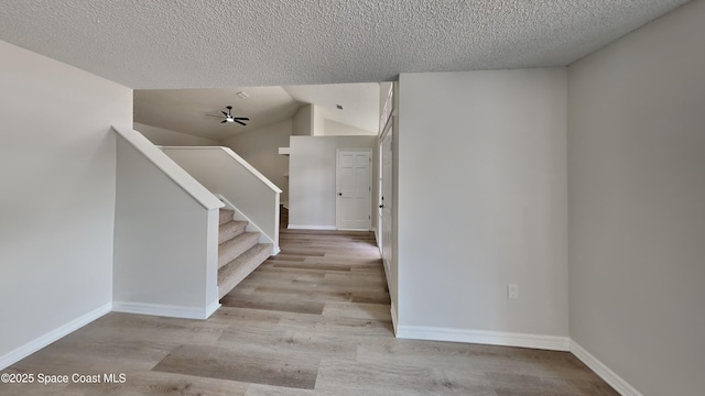 interior space featuring a textured ceiling and light hardwood / wood-style floors