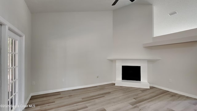 unfurnished living room with ceiling fan and light hardwood / wood-style floors