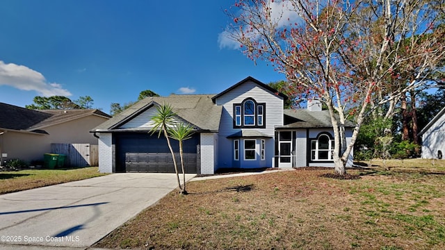 view of front property featuring a garage and a front yard