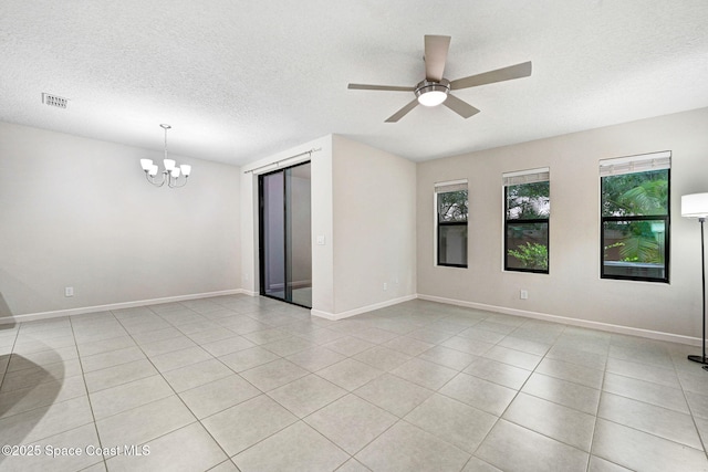 1425 Lara Cir Unit 103, Rockledge, FL 32955 - empty room with a chandelier, a textured ceiling, plenty of natural light, light tile patterned floors, and ceiling fan