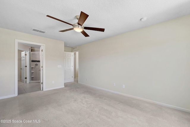 1425 Lara Cir Unit 103, Rockledge, FL 32955 - unfurnished bedroom with carpet floors, a ceiling fan, a textured ceiling, and ensuite bath