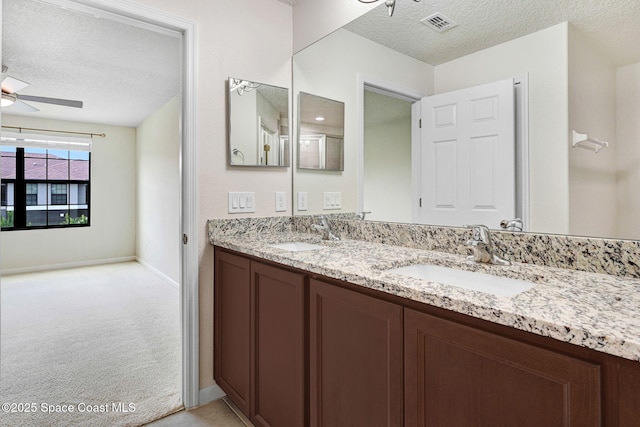 1425 Lara Cir Unit 103, Rockledge, FL 32955 - bathroom featuring a textured ceiling, double vanity, and ceiling fan