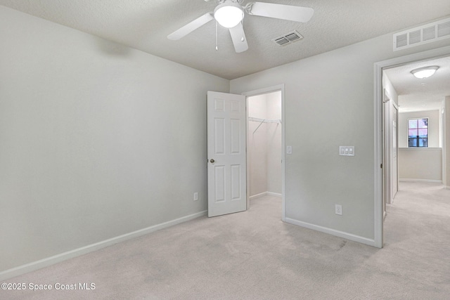 1425 Lara Cir Unit 103, Rockledge, FL 32955 - unfurnished bedroom with carpet flooring, a spacious closet, a closet, and a ceiling fan