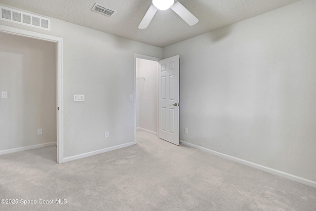 1425 Lara Cir Unit 103, Rockledge, FL 32955 - unfurnished bedroom with light carpet, a ceiling fan, and a textured ceiling