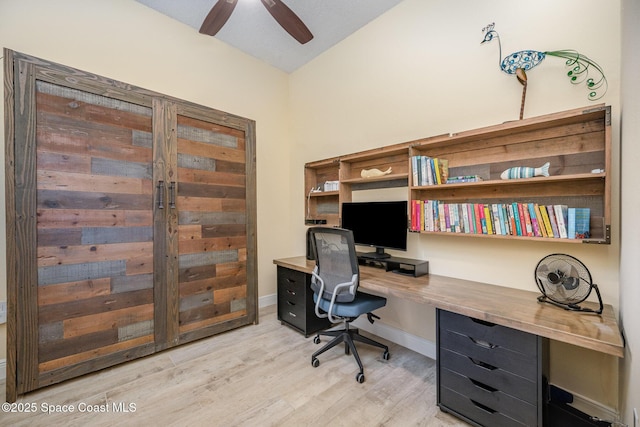 office with lofted ceiling, light wood-style floors, baseboards, and a ceiling fan