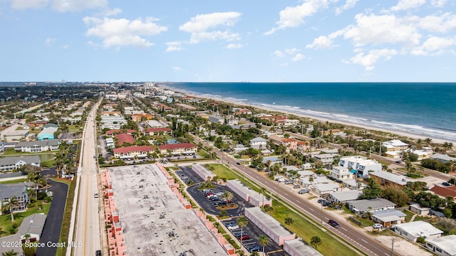 bird's eye view with a water view and a view of the beach