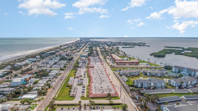 drone / aerial view with a water view and a beach view