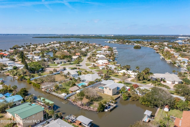 birds eye view of property with a water view and a residential view