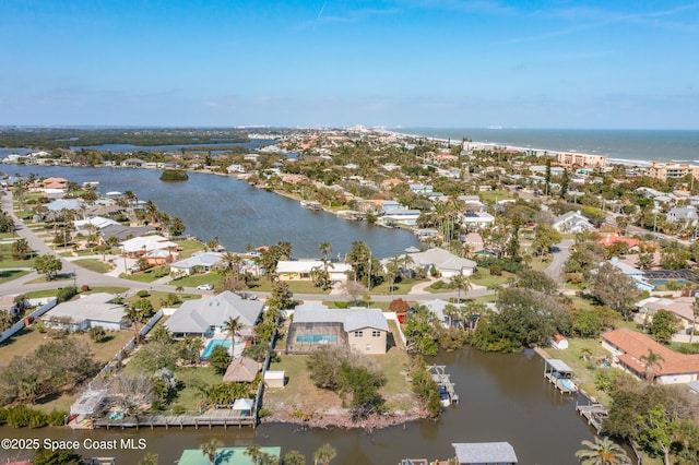 bird's eye view with a water view and a residential view