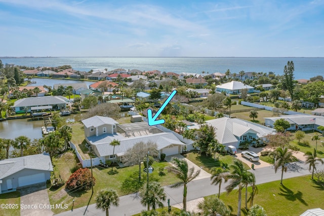 birds eye view of property with a water view and a residential view