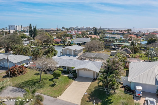 birds eye view of property featuring a water view and a residential view