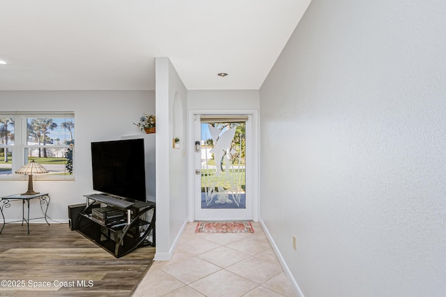 foyer with baseboards and light tile patterned floors