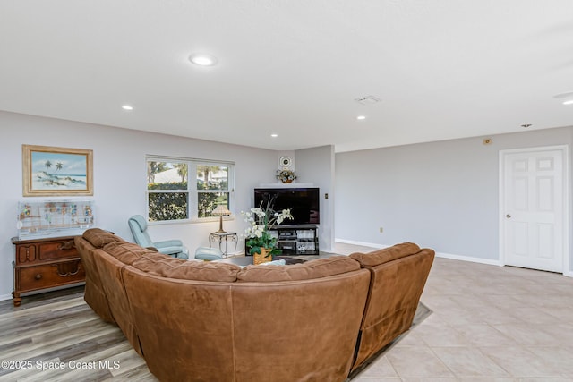 living room with baseboards and recessed lighting