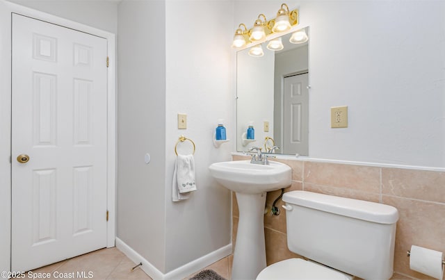 bathroom featuring tile walls, toilet, and tile patterned floors