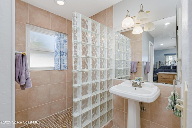 bathroom with recessed lighting, a sink, ensuite bathroom, and a walk in shower