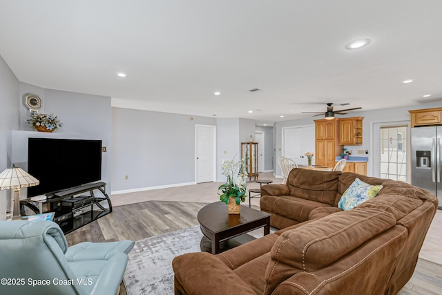 living room with baseboards, ceiling fan, light wood-style flooring, and recessed lighting