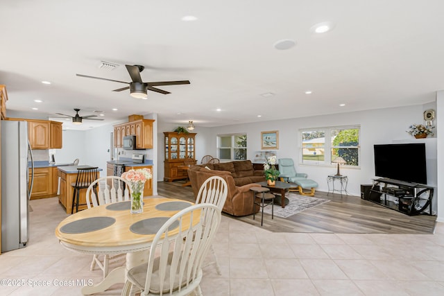 dining space with light tile patterned floors, visible vents, and recessed lighting