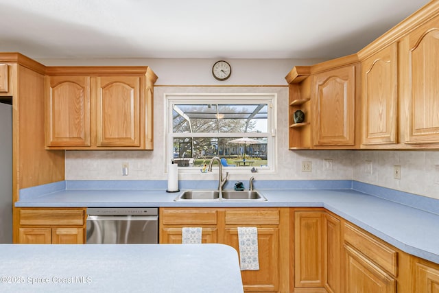 kitchen with refrigerator, light countertops, a sink, and stainless steel dishwasher