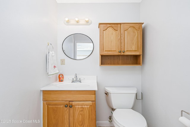 half bathroom with vanity and toilet