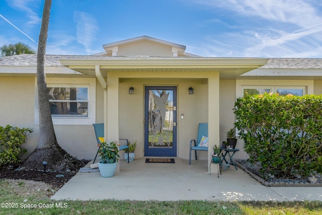 property entrance featuring stucco siding