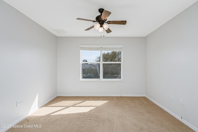 unfurnished room featuring a ceiling fan, carpet flooring, and baseboards