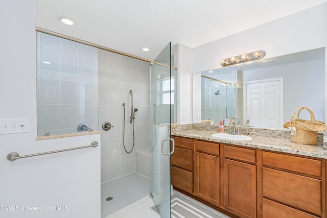 full bath featuring a stall shower, tile patterned flooring, and vanity