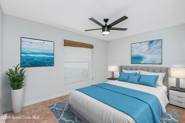 bedroom featuring a ceiling fan, baseboards, and light tile patterned floors