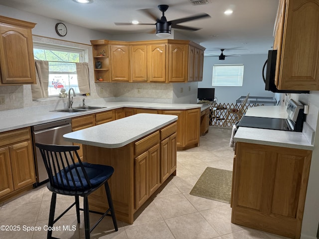1529 Bay Shore Dr, Cocoa Beach, FL 32931 - kitchen with ceiling fan, stainless steel dishwasher, healthy amount of natural light, a center island, and recessed lighting