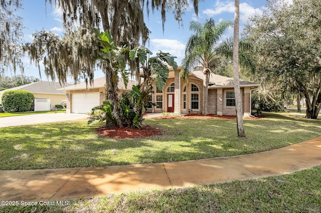 view of front of house featuring a garage and a front lawn