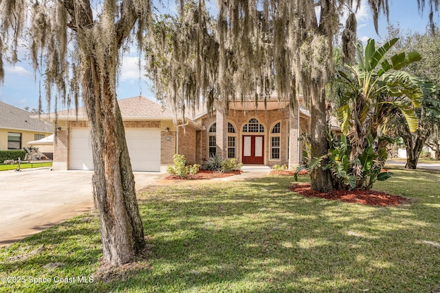 view of front of house with a garage and a front lawn