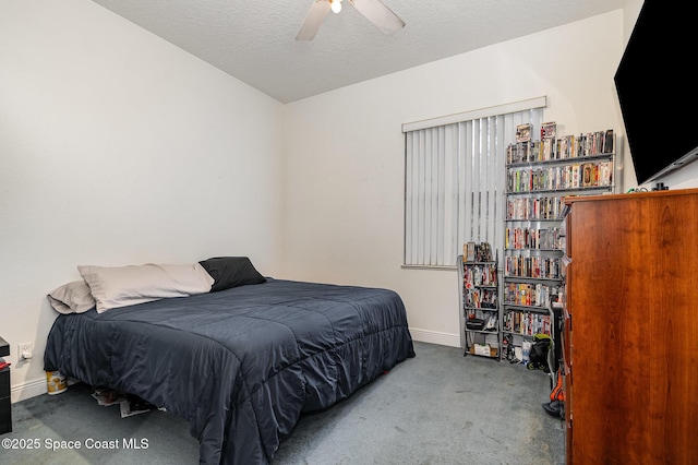 bedroom featuring ceiling fan, carpet, and a textured ceiling