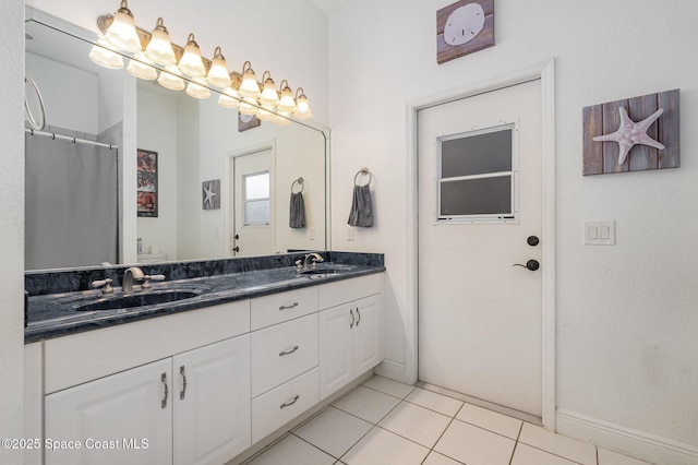 bathroom featuring vanity, toilet, curtained shower, and tile patterned flooring