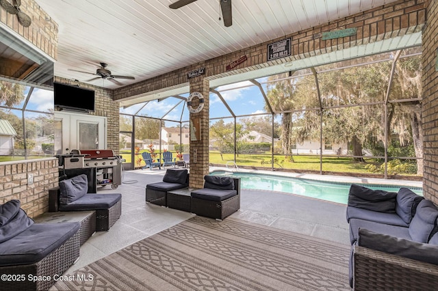 view of patio with a lanai, an outdoor hangout area, and ceiling fan