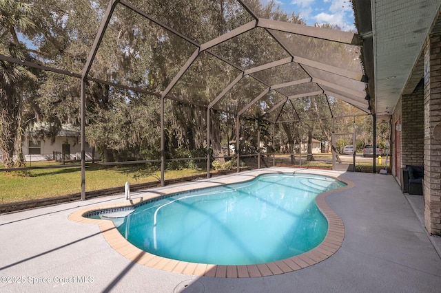 view of swimming pool with a patio area, a lawn, and glass enclosure